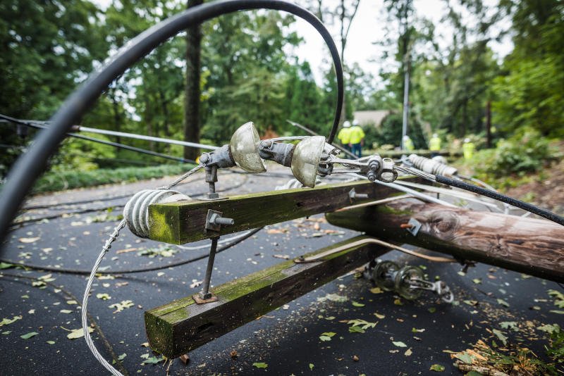 A damaged power pole lay on the ground